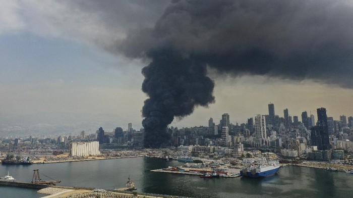 Black smoke rises from a fire at warehouses at the seaport in Beirut, Lebanon, Thursday, Sept. 10. 2020. A huge fire broke out Thursday at the Port of Beirut, triggering panic among residents traumatized by last months massive explosion that killed and injured thousands of people. (AP Photo/Hussein Malla)