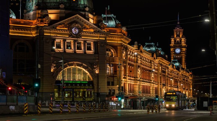 MELBOURNE, AUSTRALIA - SEPTEMBER 10: A lone tram travels past a deserted Flinders Street on September 10, 2020 in Melbourne, Australia. Melbourne residents are currently experiencing some of the strictest and longest coronavirus lockdown measures in the world as Victoria continues to work to contain a second wave of COVID-19 infections. Under stage 4 lockdown restrictions, which came into effect on 2 August 2020, people are only allowed to leave home to give or receive care, shopping for food and essential items, daily exercise and work while an overnight curfew from 8pm to 5am is also in place. Originally scheduled to end on September 13, Melbournes tough stage four lockdown has been extended for a further two weeks after the Victorian government announced COVID-19 case numbers remained too high for a safe return to a more normal way of life. (Photo by Asanka Ratnayake/Getty Images)