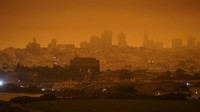 Meteorolog Judson Jones menjelaskan perubahan warna itu terjadi seiring dengan makin tebalnya asap dan abu di dekat kebakaran hutan. Asap dan abu itu kemudian memotong sinar matahari sehingga langit berubah warna seperti ini. AP Photo/Eric Risberg.