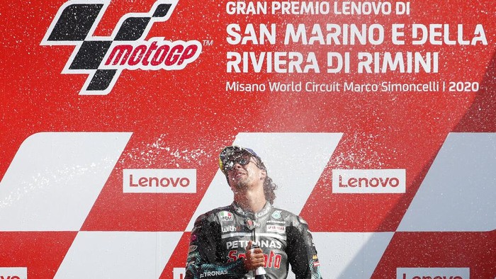MotoGP rider Franco Morbidelli of Italy celebrates on the podium after winning the San Marino Motorcycle Grand Prix at the Misano circuit in Misano Adriatico, Italy, Sunday, Sept. 13, 2020. (AP Photo/Antonio Calanni)