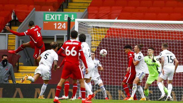 Liverpool's Virgil van Dijk, left, scores his side's second goal during the English Premier League soccer match between Liverpool and Leeds United, at the Anfield stadium, in Liverpool, Saturday, Sept. 12, 2020. (Phil Noble, Pool via AP)