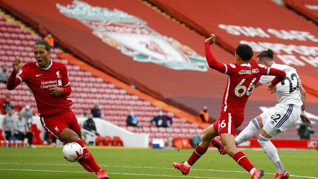 Leeds United's Jack Harrison scores his side's first goal during the English Premier League soccer match between Liverpool and Leeds United, at the Anfield stadium, in Liverpool, Saturday, Sept. 12, 2020. (Phil Noble, Pool via AP)