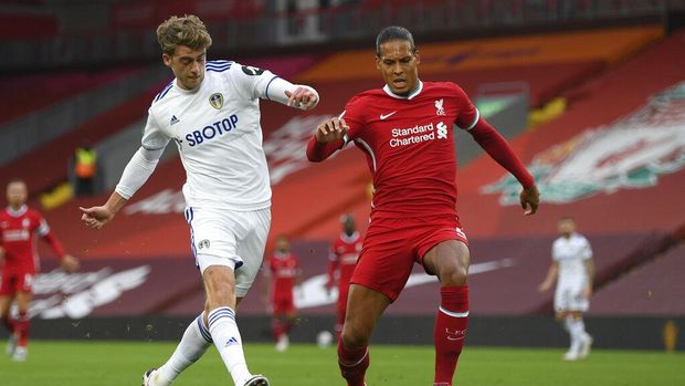 Leeds United's Patrick Bamford, left, scores his side's second goal during the English Premier League soccer match between Liverpool and Leeds United, at the Anfield stadium, in Liverpool, Saturday, Sept. 12, 2020. (Shaun Botterill, Pool via AP)