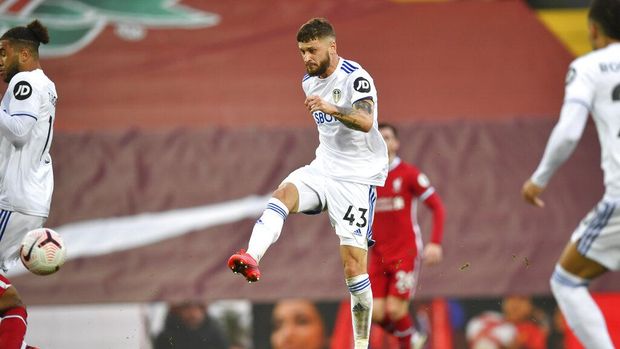 Leeds United's Mateusz Klich, center, scores his side's third goal during the English Premier League soccer match between Liverpool and Leeds United, at the Anfield stadium, in Liverpool, Saturday, Sept. 12, 2020. (Paul Ellis, Pool via AP)