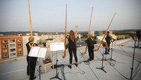 Para musisi memberi hormat setelah memainkan musik di akhir konser yang diselenggarakan di atas atap apartemen tersebut.