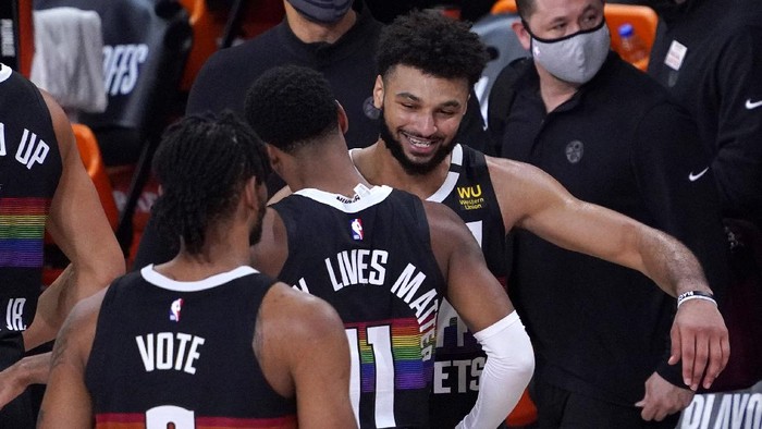 Denver Nuggets Jamal Murray, right, celebrates with Monte Morris (11) after an NBA conference semifinal playoff basketball against the Los Angeles Clippers game Sunday, Sept. 13, 2020, in Lake Buena Vista, Fla. The Nuggets won 111-98. (AP Photo/Mark J. Terrill)