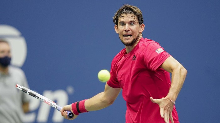 Dominic Thiem, of Austria, holds up the championship trophy after defeating Alexander Zverev, of Germany, in the men's singles final of the US Open tennis championships, Sunday, Sept. 13, 2020, in New York. (AP Photo/Seth Wenig)