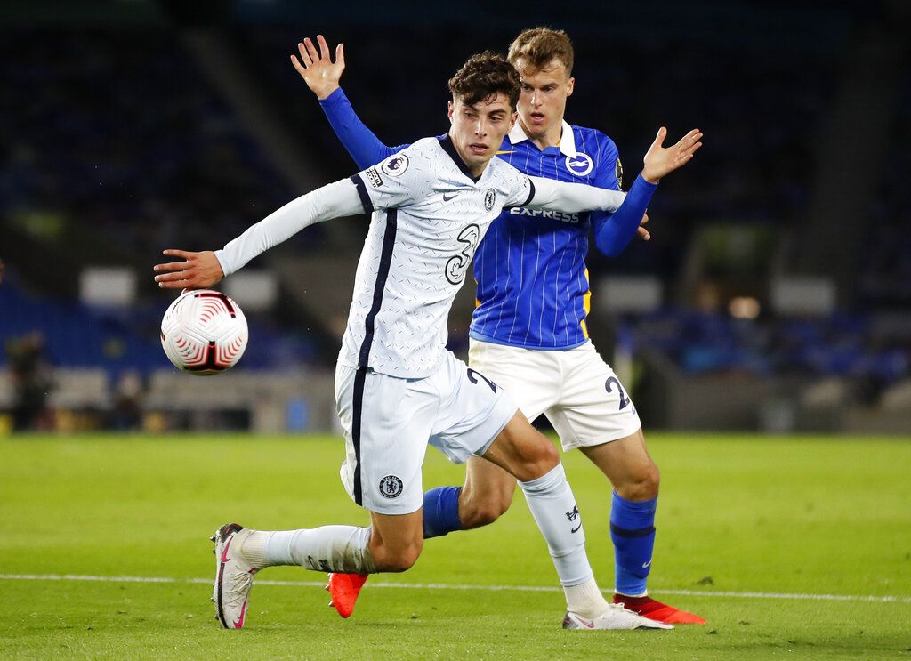 Chelsea's Kai Havertz, left, and Brighton's Solly March battle for the ball during the English Premier League soccer match between Brighton and Chelsea at Falmer Stadium in Brighton, England, Monday, Sept. 14, 2020. (Peter Cziborra/Pool via AP)