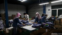 Para karyawan pergudangan memakai masker untuk mencegah penyebaran COVID-19.
