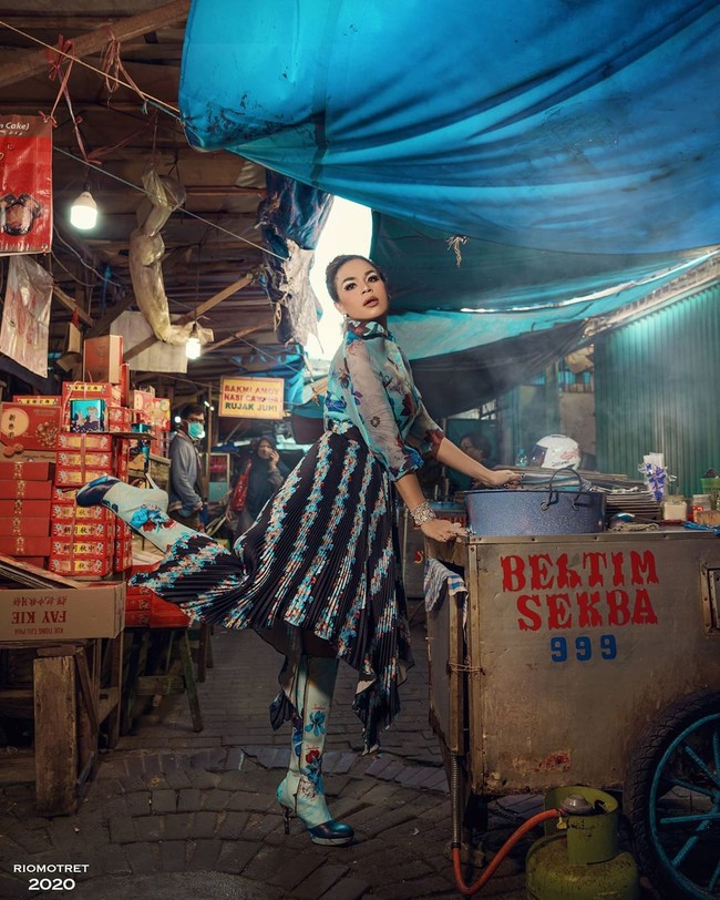 Di pemotretan berikutnya, giliran busana bernuansa biru penuh motif floral yang membungkus tubuh Melaney Ricardo. Busana dipadukan dengan rok lipit dan rok bermotif sama. Sebagai sentuhan akhir, anting dan gelang berlian ikut menyempurnakan gayanya. Ngomong-ngomong look yang dipakai Melaney ini, from head to toe Rp 800 juta dan bakalan dipakai di tengah-tengah pasar, ungkap Rio di video behind the scene pemotretan yang tayang di YouTube. (Foto: Instagram@riomotret)