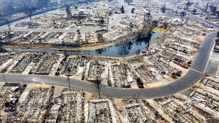 In this photo taken by a drone, homes leveled by the Almeda Fire line the Bear Lake Estates in Phoenix, Ore., Tuesday, Sept. 15, 2020. (AP Photo/Noah Berger)