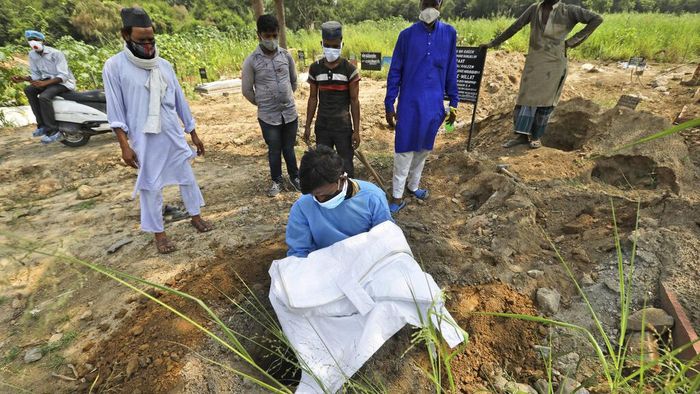 Potret Pilu Pria India Makamkan Putranya yang Tewas Akibat COVID-19 Seorang pria di India memakamkan putranya yang tewas akibat COVID-19. Seperti diketahui, Kasus sedikitnya 82 ribu orang tewas akibat COVID-19 di India.