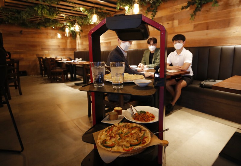 Lee Youngjin, team leader of AI Platform Business Team at KT Corp., speaks about AI serving robot ahead of a demonstration at a restaurant in Seoul, South Korea, Tuesday, Sept. 15, 2020.  (AP Photo/Lee Jin-man)