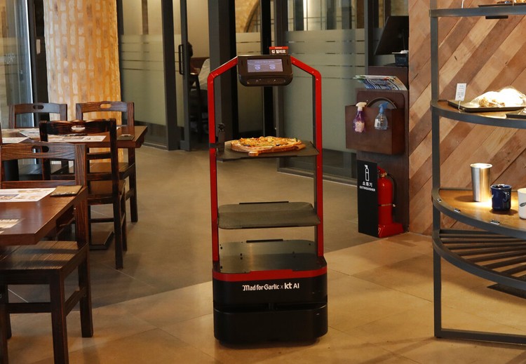 Lee Youngjin, team leader of AI Platform Business Team at KT Corp., speaks about AI serving robot ahead of a demonstration at a restaurant in Seoul, South Korea, Tuesday, Sept. 15, 2020.  (AP Photo/Lee Jin-man)