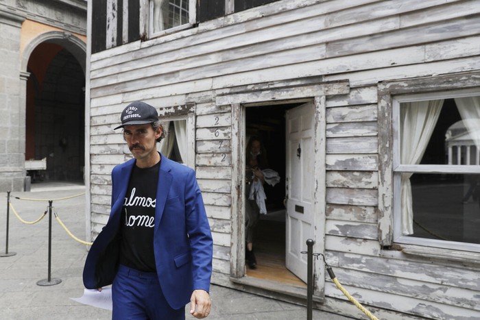 Visitors look through a window of the house of U.S. civil rights campaigner Rosa Parks, rebuilt by artist Ryan Mendoza, for public display, in Naples, Italy, Tuesday, Sept. 15, 2020. It’s the latest stop for the house in a years-long saga that began when Parks’ niece saved the tiny two-story home from demolition in Detroit after the 2008 financial crisis. (AP Photo/Gregorio Borgia)