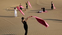 Para penari bersiap untuk melakukan yoga di bukit pasir Gurun Xiangshawan, juga disebut Gurun Pasir Sounding di Ordos, Daerah Otonomi Mongolia Dalam, Cina.  