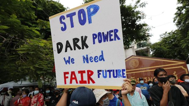 Pro-democracy protesters sit in front of a three-finger resistance symbol sign during a protest outside Thammasat University in Bangkok, Thailand on Saturday, September 19, 2020. Protesters gathered in Bangkok on Saturday to what was expected to be the largest demonstration yet, in an ongoing campaign calling for a new election and democratic reforms.  (AP Photo / Sakchai Lalit)