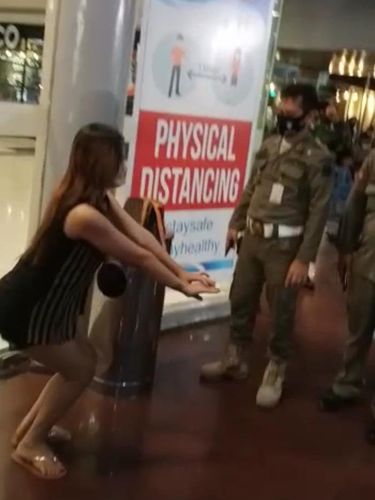 Viral petugas berkeliling 'menonton' wanita tak bermasker yang dihukum di sebuah mal di Manado (Screenshot video viral)