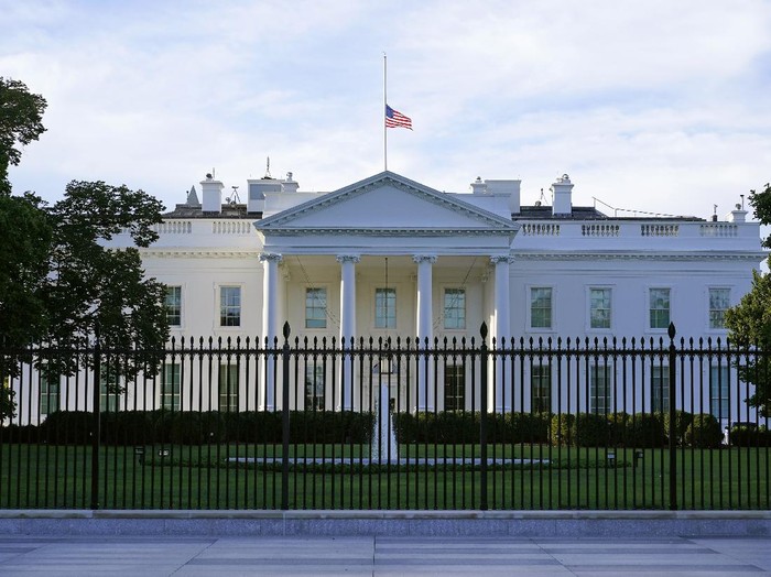 FILE - In this Saturday, Sept. 19, 2020, file photo, an American flag flies at half-staff over the White House in Washington. A woman suspected of sending an envelope containing the poison ricin, which was addressed to White House, has been arrested at the New York-Canada border. (AP Photo/Patrick Semansky, File)