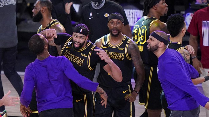 Los Angeles Lakers Anthony Davis, second from left, celebrates with teammates after an NBA conference final playoff basketball game against the Denver Nuggets Sunday, Sept. 20, 2020, in Lake Buena Vista, Fla. The Lakers won 105-103. (AP Photo/Mark J. Terrill)