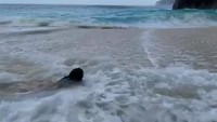 Mau pose di pantai yang cantik eh malah diterjang ombak besar.