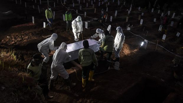 Petugas penggali makam jenazah COVID-19 menulis nama dan kelompok yang bertugas di komplek pemakaman Pondok Ranggon.