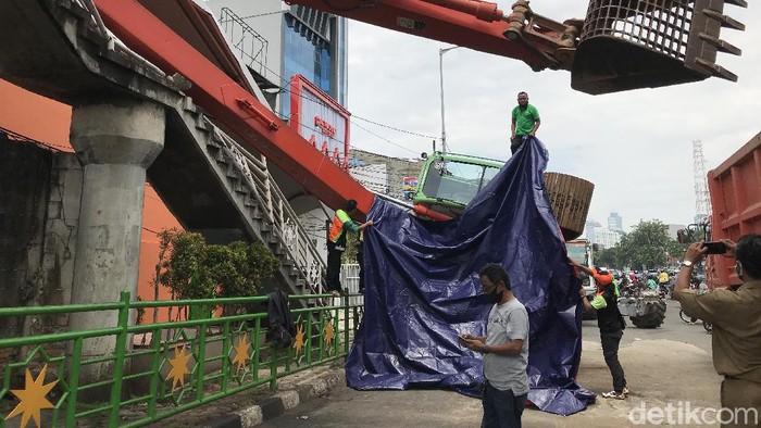 Eskavator terguling di Kampung Melayu, hancurkan tangga JPO