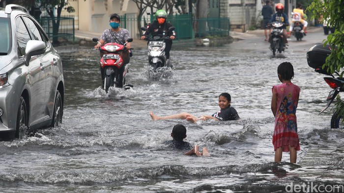 Pasca hujan deras semalem, terdapat genangan air di depan Perumahan Green Garden, Kedoya, Jakarta. Genangan ini menjadi tempat main anak-anak.