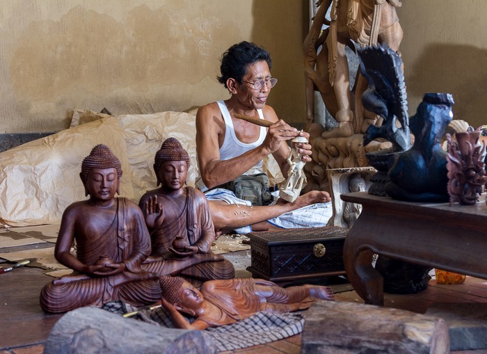 A man is making wooden crafts  in Indonesia