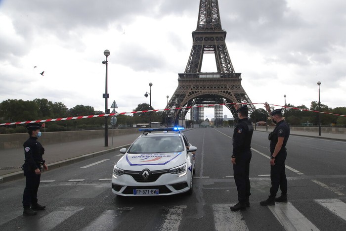 French police officers secure the bridge leading to the Eiffel Tower, Wednesday, Sept. 23, 2020 in Paris. Paris police have blockaded the area around the Eiffel Tower after a phone-in bomb threat. (AP Photo/Michel Euler)