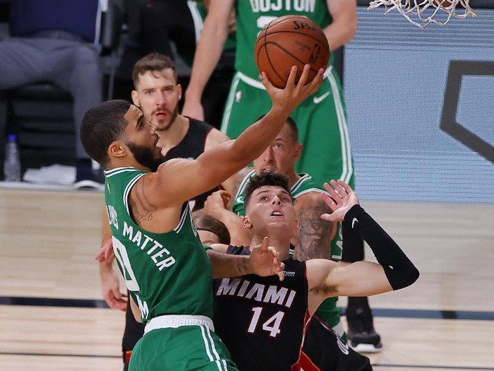 LAKE BUENA VISTA, FLORIDA - SEPTEMBER 19: Jayson Tatum #0 of the Boston Celtics drives to the basket against Tyler Herro #14 of the Miami Heat during the fourth quarter in Game Three of the Eastern Conference Finals during the 2020 NBA Playoffs at AdventHealth Arena at the ESPN Wide World Of Sports Complex on September 19, 2020 in Lake Buena Vista, Florida. NOTE TO USER: User expressly acknowledges and agrees that, by downloading and or using this photograph, User is consenting to the terms and conditions of the Getty Images License Agreement.   Kevin C. Cox/Getty Images/AFP