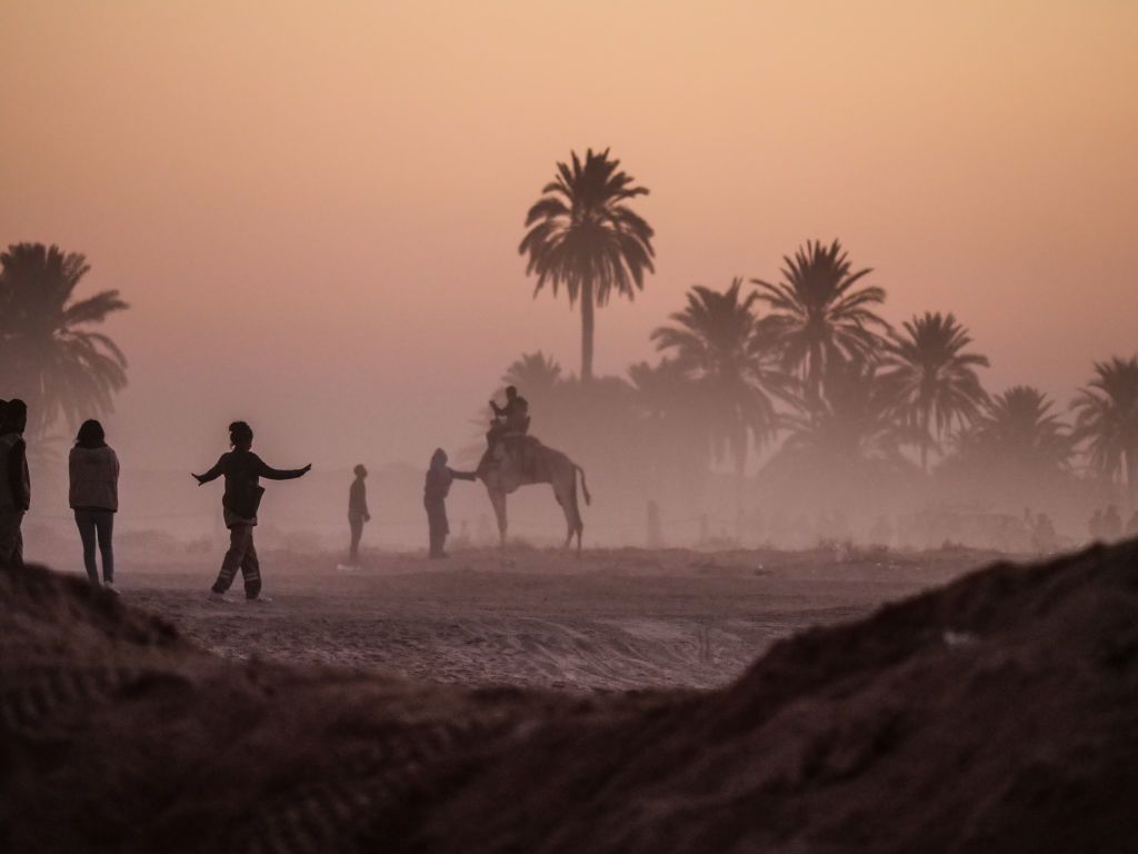 DOUZ, TUNISIA - DECEMBER 23: A person rides a camel after the conclusion of the last day of activities at the Sahara Festival on December 23, 2018 in Douz, Tunisia. The Sahara Festival, in its 51st year, brings together nomadic peoples of this Sahara region and celebrates their culture in a four day event showcasing music, racing and performances. (Photo by Stephanie Keith/Getty Images for Lumix)