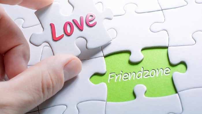 Close-up of two hands making a thumb up sign, half heart on a blue background, copy space. Friendzone concept, romantic relationship, flirting