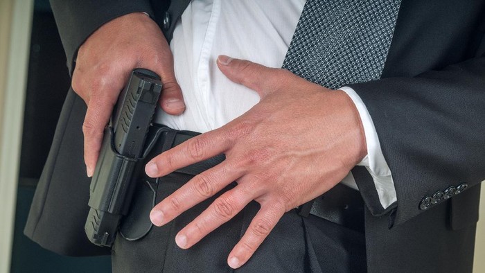Security staff armed with handgun.