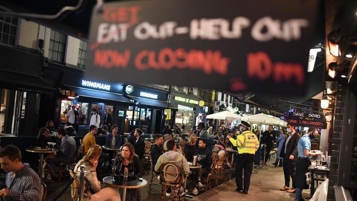 LONDON, ENGLAND - SEPTEMBER 24: A waiter keeps chairs from a pub in Soho on September 24, 2020 in London, England. Pubs, cafes and restaurants will have to shut at 10pm every night under new measures to control the rising rate of coronavirus. (Photo by Peter Summers/Getty Images)