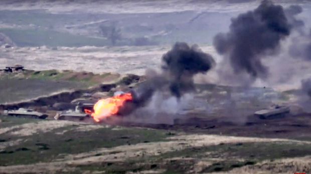 In this image taken from footage released by the Armenian Defense Ministry on Sunday, September 27, 2020, Armenian forces destroy the Azerbaijani tank on the contact line of the self-proclaimed Republic of Nagorno-Karabakh, Azerbaijan.  Clashes between Armenia and Azerbaijan have broken out around the breakaway Nagorno-Karabakh region and the Armenian Defense Ministry says two Azerbaijani helicopters have been shot down.  Ministry spokeswoman Shushan Stepanyan also said that Armenian forces attacked three Azerbaijani tanks.  (Ministry of Defense of Armenia via AP)