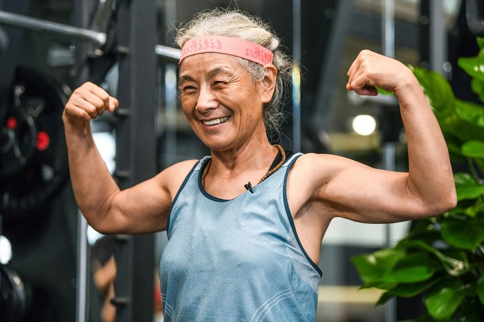 This photo taken on September 17, 2020 shows Chen Jifang, 68, working out at a gym in Shanghai. - The grandmother from Shanghai has become a minor celebrity in recent months in China as her newfound and unlikely love for working out made national headlines. (Photo by STR / AFP) / China OUT / TO GO WITH AFP STORY CHINA-SPORT-LIFESTYLE-ELDERLY by Peter STEBBINGS and Jessica YANG / The erroneous mention[s] appearing in the metadata of this photo by STR has been modified in AFP systems in the following manner: [Chen Jifang, 68] instead of [Chen Jifang, 70]. Please immediately remove the erroneous mention[s] from all your online services and delete it (them) from your servers. If you have been authorized by AFP to distribute it (them) to third parties, please ensure that the same actions are carried out by them. Failure to promptly comply with these instructions will entail liability on your part for any continued or post notification usage. Therefore we thank you very much for all your attention and prompt action. We are sorry for the inconvenience this notification may cause and remain at your disposal for any further information you may require.
