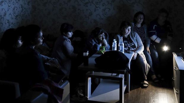 In this photo released by the Armenian Ministry of Foreign Affairs on Monday, September 28, 2020, people watch state television as they gather in a bomb shelter to protect themselves against shelling in Stepanakert, the self-proclaimed Republic of Nagorno-Karabakh, Azerbaijan. .  .  The Nagorno-Karabakh authorities reported that the bombings reached the region's capital, Stepanakert, and the towns of Martakert and Martuni.  Armenian Defense Ministry spokesman Artsrun Hovhannisyan also said Azerbaijani bombardments fell within Armenian territory near the city of Vardenis.  (Ministry of Foreign Affairs of Armenia via AP)