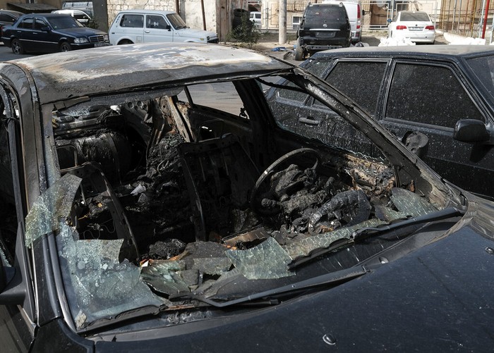 A car destroyed by shelling in Stepanakert, the self-proclaimed Republic of Nagorno-Karabakh, Azerbaijan, Tuesday, Sept. 29, 2020. Armenian and Azerbaijani forces accused each other of attacks on their territory Tuesday, as fighting over the separatist region of Nagorno-Karabakh continued for a third straight day following the reigniting of a decades-old conflict. (Areg Balayan/PAN Photo via AP)