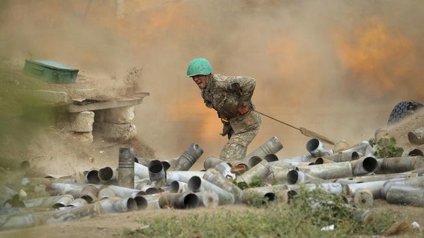 An Armenian serviceman fires a cannon towards Azerbaijan positions in the self-proclaimed Republic of Nagorno-Karabakh, Azerbaijan, Tuesday, Sept. 29, 2020. Armenian and Azerbaijani forces accused each other of attacks on their territory Tuesday, as fighting over the separatist region of Nagorno-Karabakh continued for a third straight day following the reigniting of a decades-old conflict. (Sipan Gyulumyan/Armenian Defense Ministry Press Service/PAN Photo via AP)