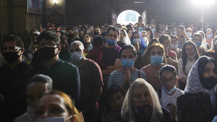 People attend a nationwide prayer for peace lead by Catholicos Karekin II in the Saint Gayane Church in Yerevan, Armenia, Saturday, Oct. 3, 2020. Armenia and Azerbaijan say heavy fighting is continuing in their conflict over the separatist territory of Nagorno-Karabakh and Azerbaijan's president said late Saturday that his troops had taken a village.(Grigor Yepremyan/PAN Photo via AP)