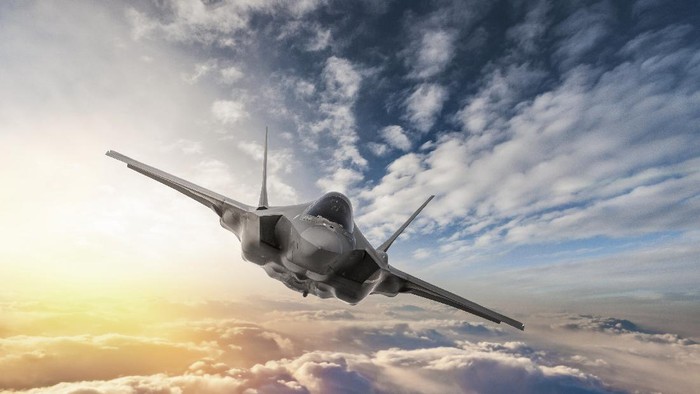 Fighter Jet flying over the clouds at sunset