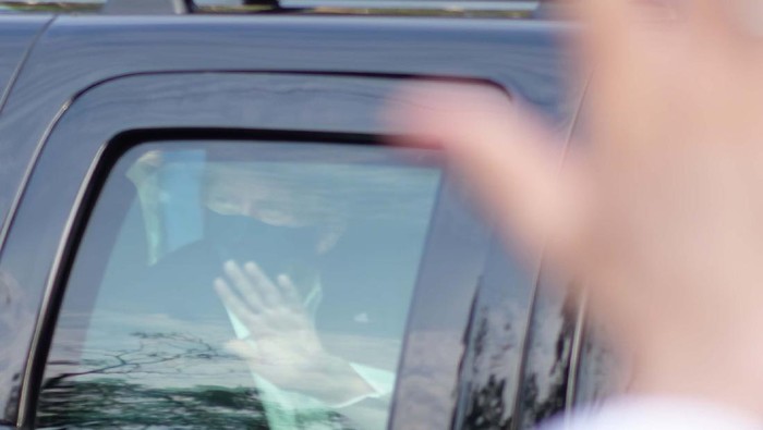 President Donald Trump drives past supporters gathered outside Walter Reed National Military Medical Center in Bethesda, Md., Sunday, Oct. 4, 2020. Trump was admitted to the hospital after contracting COVID-19. (AP Photo/Anthony Peltier)