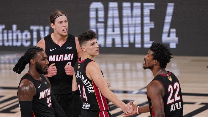 Miami Heats Tyler Herro, center, high fives Jimmy Butler (22) along with Kelly Olynyk, top left, and Jae Crowder, left, after a win against Los Angeles Lakers 115-104 after Game 3 of basketballs NBA Finals, Sunday, Oct. 4, 2020, in Lake Buena Vista, Fla. (AP Photo/Mark J. Terrill)