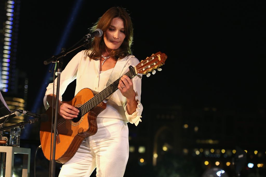 Carla Bruni DUBAI, UNITED ARAB EMIRATES - OCTOBER 30: Carla Bruni performs live at the Gala event during the Vogue Fashion Dubai Experience 2015 at Armani Hotel Dubai on October 30, 2015 in Dubai, United Arab Emirates. (Photo by Luca Teuchmann/Getty Images for Vogue and The Dubai Mall)