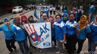 Buruh menggelar aksi dengan mengenakan seragam dari pabrik masing-masing.