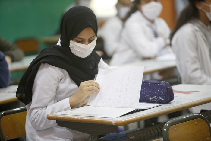 13-year-old student Chaimaa Talaaloute wears a face mask in the classroom at Mansour Eddahbi College in the Derb El Kabir district of the AL Fida prefecture in Casablanca, Morocco, on Monday, Oct. 5, 2020. Today it is the start of the school year in Casablanca, with a delayed start due to the COVID-19 pandemic. (AP Photo/Abdeljalil Bounhar)