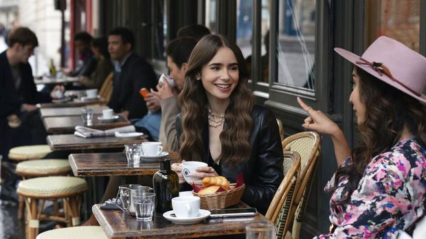 This image released by Netflix shows William Abadie, left, and Lily Collins in a scene from the series 