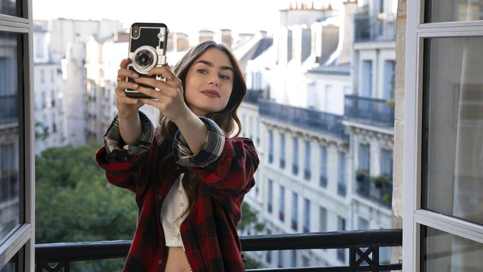 This image released by Netflix shows William Abadie, left, and Lily Collins in a scene from the series 