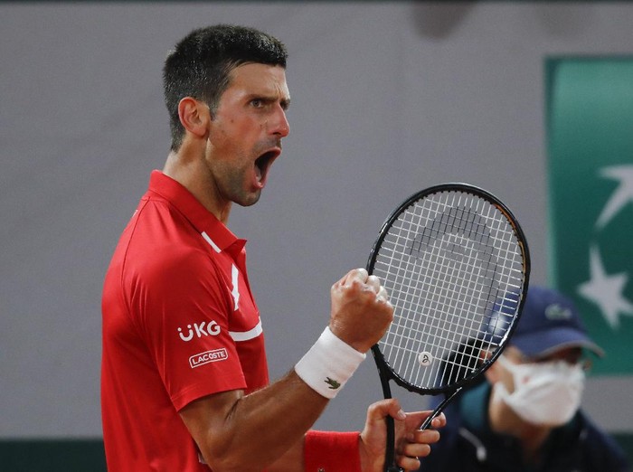 Serbias Novak Djokovic clenches his fist after scoring a point against Russias Karen Khachanov in the fourth round match of the French Open tennis tournament at the Roland Garros stadium in Paris, France, Monday, Oct. 5, 2020. (AP Photo/Christophe Ena)